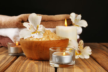 Spa still life on wooden table on black background