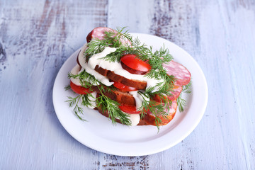 Sandwich with sausage, tomato and mayonnaise