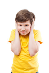 Young boy in yellow t-shirt shuts his ears by hands - 79666082