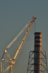 Power plant. Crane at a construction site. Chimney and smoke