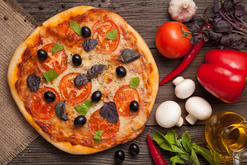Traditional baked italian pizza margherita with tomatoes olives