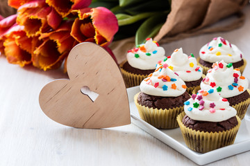Mothers day  chocolate   with spring tulips and wooden h