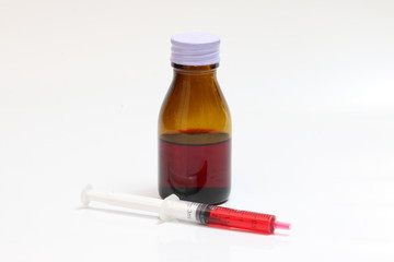 Bottle pouring Medicine Syrup in Spoon