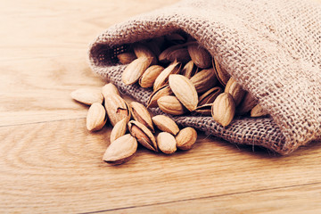Almonds on rustic wooden background.