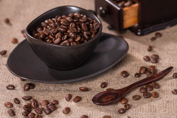 coffee beans in a coffee cup on sackcloth