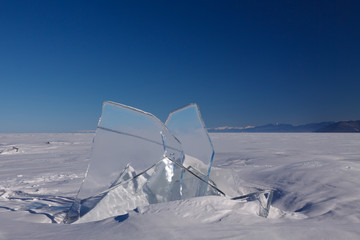 Fototapeta na wymiar Transparent block of ice on Baikal lake
