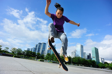 skateboarder practice skateboarding trick ollie at city