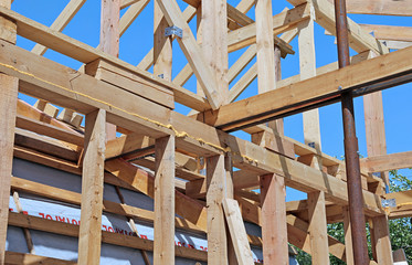 Installation of wooden beams at construction