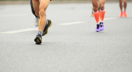 Fototapeta premium marathon runner legs running on city street
