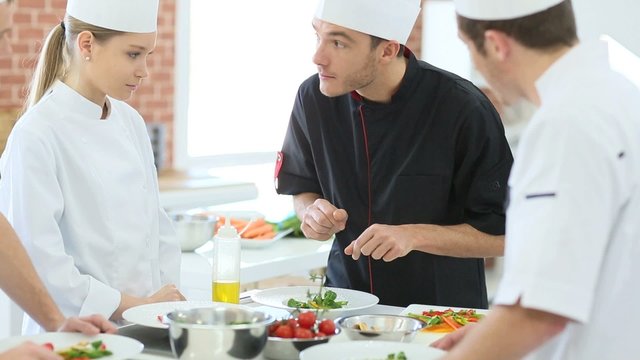 Chef teaching students how to prepare dish