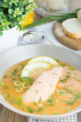 Salmon soup on wooden desk background