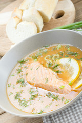 Salmon soup on wooden desk background