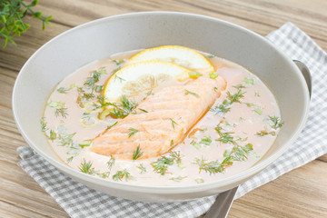 Salmon soup on wooden desk background