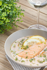 Salmon soup on wooden desk background