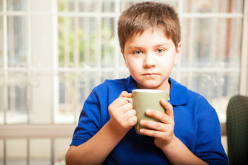 Little boy drinking coffee