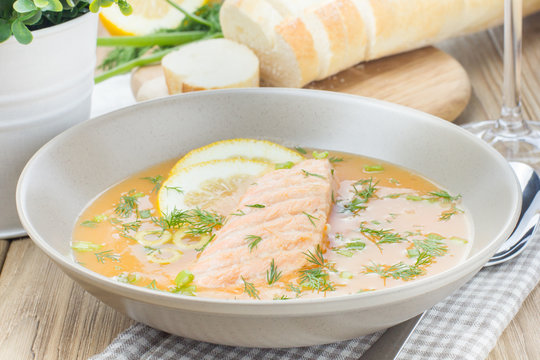 Salmon soup on wooden desk background