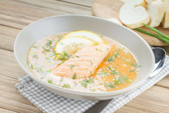 Salmon soup on wooden desk background