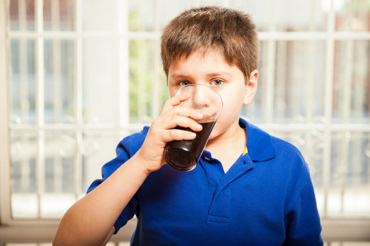 Kid Drinking Soda From A Glass