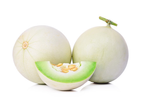 Honeydew melon sliced in half isolated on white