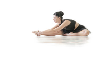 Fototapeta na wymiar Young alternative ballerina stretching isolated on white