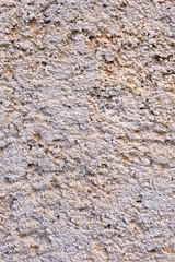 Closeup of a wall of sand and cement