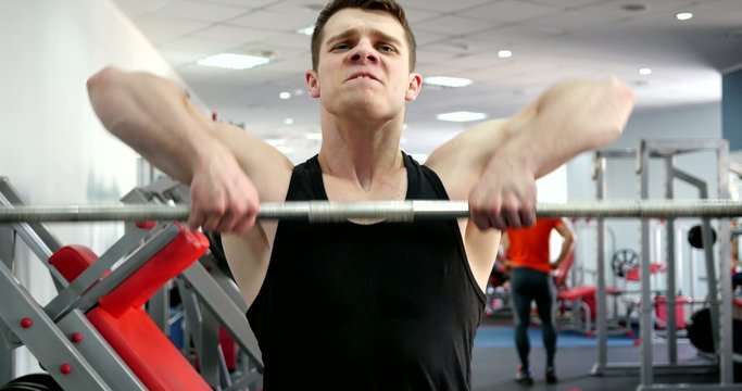 Sports man hard training in gym