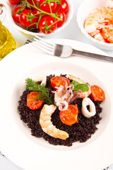 black rice with squid , prawns and tomatoes