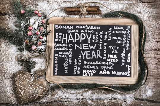 Black charcoal board with caption "Happy New Year" in many langu