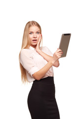 The surprised, young woman with tablet PC, isolated on white bac