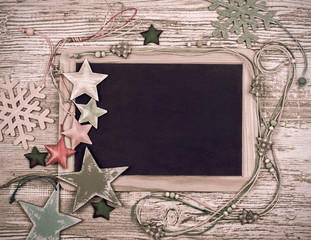 Black chalkboard with various winter decorations