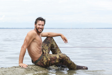 Portrait of Smiling Athletic Army with No Shirt