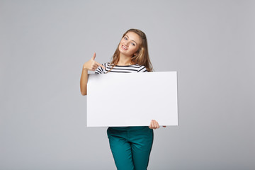 Full length of beautiful woman standing behind, holding white bl