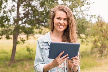 Happy young woman using tablet pc