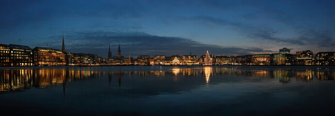 Night cityscape of Hamburg. Panorama of evening lights on the Alster lake of Hamburg, Germany.