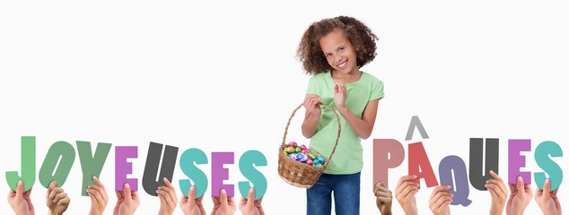 Composite image of hands holding up joyeuses pasques
