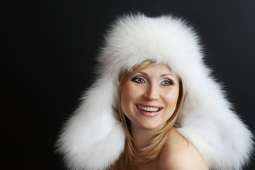 Portrait of a smiling  young  woman in  fur hat