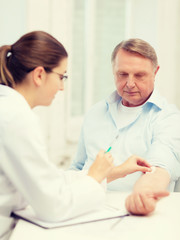 female doctor doing injection to old man