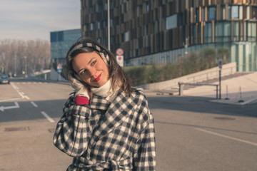 Fototapeta premium Beautiful young brunette posing in the city streets