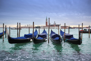 Fototapeta na wymiar San Giorgio Maggiore church with moored gondolas