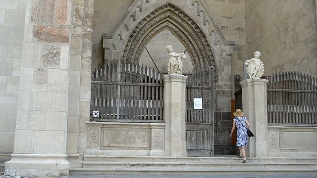 Young Woman Walks into Gothic Church