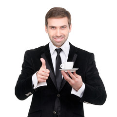 Perfect coffee. Handsome smiling businessman holding a cup of co