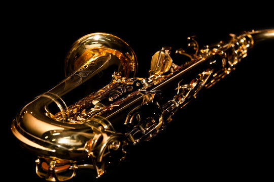 Lying saxophone on black background in dark colors