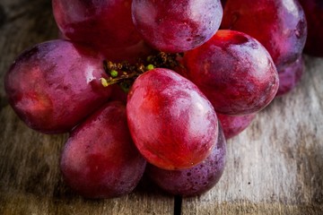 organic ripe grapes closeup on wooden background