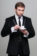 Portrait of attractive businessman drinking coffee