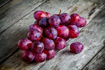 organic ripe grapes on wooden background