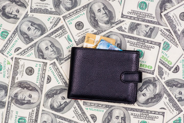 Black purse (wallet) with credit cards on american money backdro