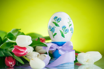 Decorative easter egg with a bouquet of spring tulips