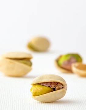 Close up image of an open pistachio nut and shell
