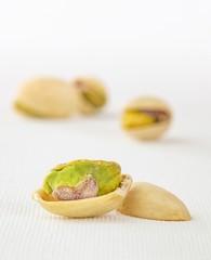 Close up image of an open pistachio nut and shell