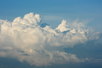 Fototapeta na wymiar Cloudscape. White cumulus clouds are like a snow-covered mountain peaks.